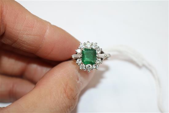 A white metal, emerald and diamond cluster dress ring, size M.